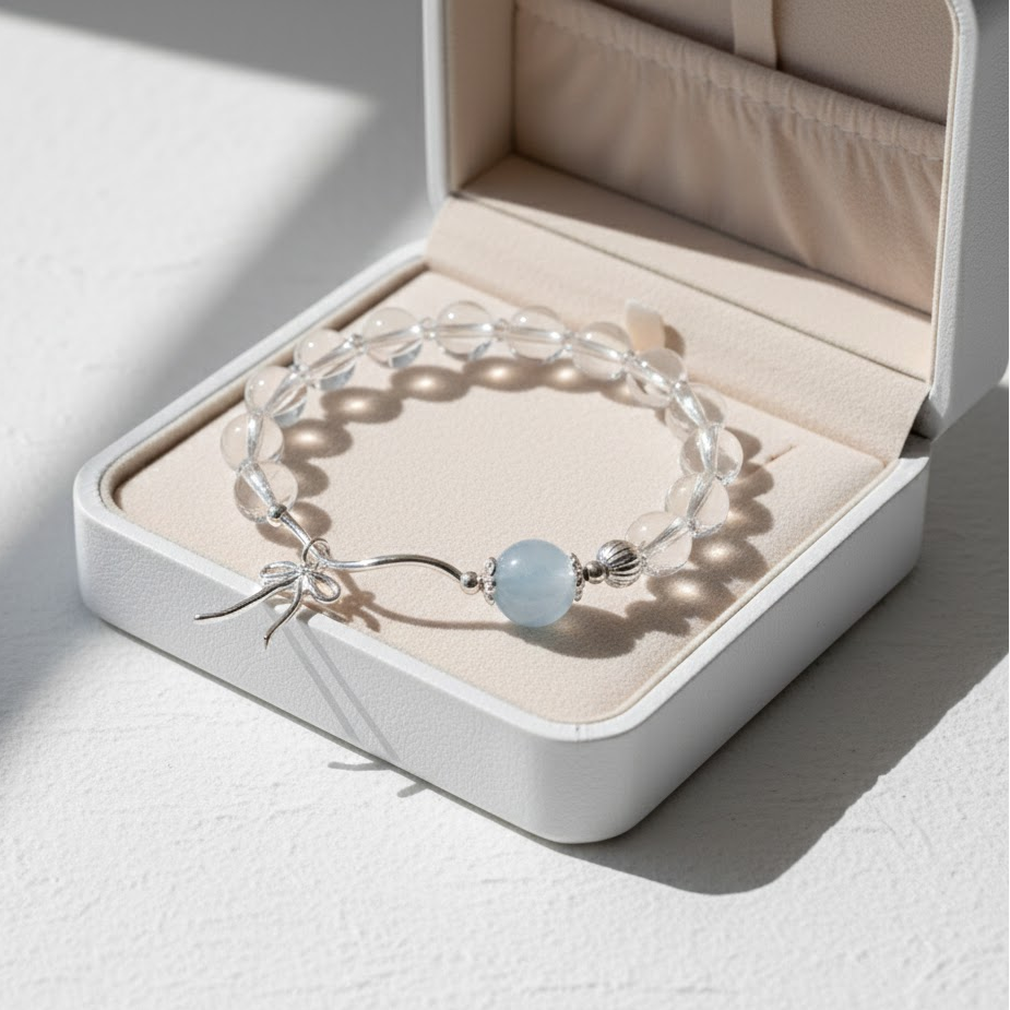 Bracelet with a blue bead in an open jewelry box on a light surface